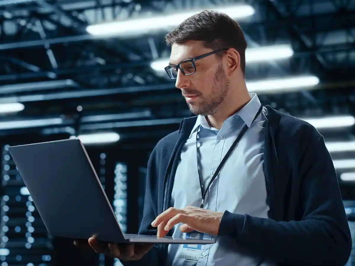 A cybersecurity expert performing looking at his laptop