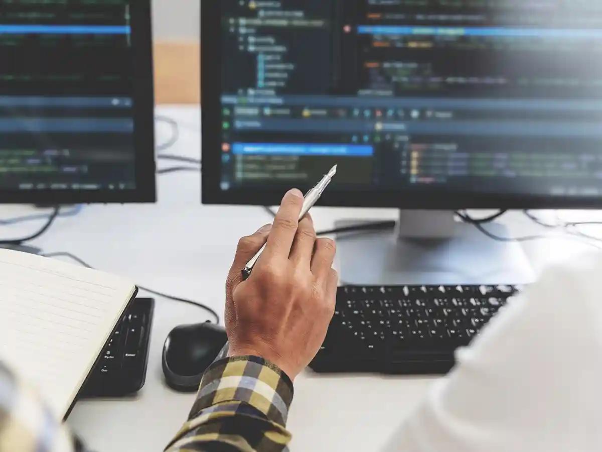The hand of a cybersecurity expert at his computer